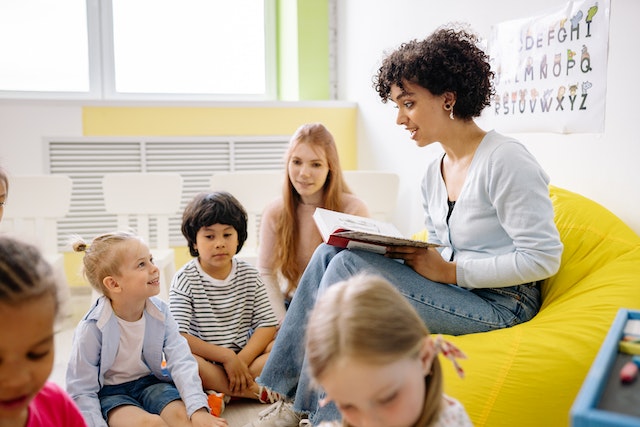 Young teacher reads to a group of children
